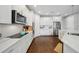 Modern kitchen features white cabinetry, stainless steel appliances, subway tile backsplash, and quartz countertops at 2904 W Averill Ave, Tampa, FL 33611