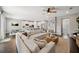 Open-concept living room features a large sectional sofa, wood floors, and bright natural light at 2904 W Averill Ave, Tampa, FL 33611