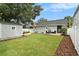 Backyard with a wooden deck, manicured lawn, storage shed, and privacy fence at 2910 W Aquilla St, Tampa, FL 33629