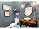 Stylish powder room with wooden countertop, vessel sink, and attractive fixtures at 2910 W Aquilla St, Tampa, FL 33629