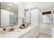 Elegant bathroom with dual sinks, quartz countertops, ample storage, and modern fixtures at 2910 W Aquilla St, Tampa, FL 33629