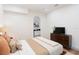 Bedroom with a wooden dresser, TV, and arched doorway to a workspace at 2910 W Aquilla St, Tampa, FL 33629