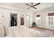 Comfortable bedroom with a ceiling fan, natural light, hardwood floors, and a walk-in closet at 2910 W Aquilla St, Tampa, FL 33629