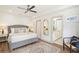 Serene bedroom with hardwood flooring, a neutral color scheme, and an attached bathroom at 2910 W Aquilla St, Tampa, FL 33629