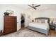 Cozy bedroom with a plush bed, wood-look flooring, and a glimpse into an adjacent sitting room at 2910 W Aquilla St, Tampa, FL 33629