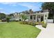 Inviting home with manicured lawn, charming front porch, and mature landscaping at 2910 W Aquilla St, Tampa, FL 33629