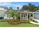 Charming home with a well-manicured lawn, lush landscaping, and inviting front porch at 2910 W Aquilla St, Tampa, FL 33629
