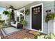 Cozy front porch with stylish seating, decorative wreath, and a welcoming doormat that says 'Home Sweet Home' at 2910 W Aquilla St, Tampa, FL 33629