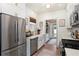 Well-lit kitchen featuring white cabinetry, stainless steel appliances, a farmhouse sink, and modern fixtures at 2910 W Aquilla St, Tampa, FL 33629