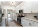 Modern kitchen with stainless steel appliances, white cabinets, sleek countertops, and hardwood flooring at 2910 W Aquilla St, Tampa, FL 33629