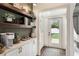 Functional laundry room with built-in shelves, a coffee station, and easy access to the outdoors at 2910 W Aquilla St, Tampa, FL 33629