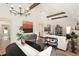 Open-concept living space featuring wood beams, stylish chandelier and natural light at 2910 W Aquilla St, Tampa, FL 33629