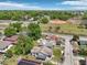Wide aerial view showcasing neighborhood streets, houses and lush greenery with ball field close by at 2920 E 20Th Ave, Tampa, FL 33605