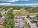 Aerial view featuring houses with baseball field nearby surrounded by trees and greenery at 2920 E 20Th Ave, Tampa, FL 33605