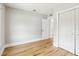 Bedroom with new wood floors, light walls, closet and door that leads to the kitchen at 2920 E 20Th Ave, Tampa, FL 33605