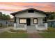 Charming home featuring white siding, black trim, covered porch, and freshly landscaped front yard at 2920 E 20Th Ave, Tampa, FL 33605