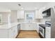 Well-lit kitchen featuring bright white cabinets, sleek countertops, and stainless-steel appliances at 2920 E 20Th Ave, Tampa, FL 33605