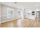 Open-concept living space with modern kitchen featuring white cabinetry and stainless steel appliances at 2920 E 20Th Ave, Tampa, FL 33605