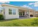 Backyard view showcasing a covered patio and green lawn at 30174 Southernwood Ct, Wesley Chapel, FL 33543