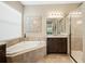 Bathroom featuring granite counters, dark cabinets, bathtub, and shower at 30174 Southernwood Ct, Wesley Chapel, FL 33543
