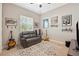 Stylish room with a leather love seat, decorative rugs, and musical decor at 30174 Southernwood Ct, Wesley Chapel, FL 33543