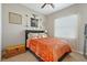 Comfortable bedroom featuring dark headboard, colorful bedspread, and ceiling fan at 30174 Southernwood Ct, Wesley Chapel, FL 33543
