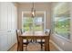 Cozy dining area featuring a rustic wooden table and a view of the outdoors at 30174 Southernwood Ct, Wesley Chapel, FL 33543