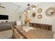 Dining room featuring a rustic wooden table, decorative wall art, and stylish pendant lighting at 30174 Southernwood Ct, Wesley Chapel, FL 33543