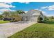 A well maintained home with a brick paved driveway and a manicured lawn in a pleasant neighborhood at 30174 Southernwood Ct, Wesley Chapel, FL 33543