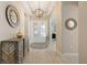 Inviting foyer featuring stylish decor, tile flooring, and double doors for a grand entrance at 30174 Southernwood Ct, Wesley Chapel, FL 33543