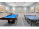 Recreation room equipped with a pool table and a ping pong table for entertainment and leisure at 30174 Southernwood Ct, Wesley Chapel, FL 33543