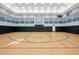 Indoor gym with a basketball court and plenty of room for players and spectators at 30174 Southernwood Ct, Wesley Chapel, FL 33543