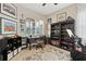Well-lit home office with desk, bookshelf, and exercise equipment perfect for work or fitness at 30174 Southernwood Ct, Wesley Chapel, FL 33543