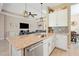 Kitchen island with granite countertops, a stainless steel dishwasher, and an open view to the living room at 30174 Southernwood Ct, Wesley Chapel, FL 33543