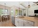Kitchen island featuring a stainless steel sink, granite countertops, and an open view to the dining and living areas at 30174 Southernwood Ct, Wesley Chapel, FL 33543