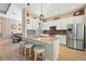 Bright kitchen featuring a large island with seating, stainless steel appliances, and pendant lighting at 30174 Southernwood Ct, Wesley Chapel, FL 33543