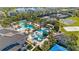 Aerial view of the pool and recreation area with a water slide, tennis courts, and a basketball court at 30174 Southernwood Ct, Wesley Chapel, FL 33543