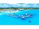 Aerial view of a community aqua park featuring slides, pools, and sandy beaches at 31408 Cabana Rye Ave, San Antonio, FL 33576