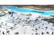 Aerial view of a resort-style beach with lounge chairs, palm trees, and an aqua park at 31408 Cabana Rye Ave, San Antonio, FL 33576