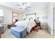 Well-lit bedroom featuring neutral tones, a cozy bed, and a decorative bench and mirror at 31408 Cabana Rye Ave, San Antonio, FL 33576