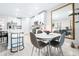 Bright dining area with seating for four, adjacent to kitchen featuring white cabinets and stainless steel appliances at 31408 Cabana Rye Ave, San Antonio, FL 33576