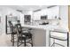 Modern kitchen boasting white cabinets, stainless steel appliances, a center island, and stylish bar stools at 31408 Cabana Rye Ave, San Antonio, FL 33576