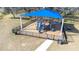 Community playground featuring a blue sunshade, play equipment and fenced-in area for safety and enjoyment at 31408 Cabana Rye Ave, San Antonio, FL 33576