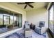 Screened porch features comfortable seating and a view to the backyard at 31408 Cabana Rye Ave, San Antonio, FL 33576