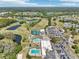 Expansive aerial view showcasing the community's golf course, pools, tennis courts, clubhouse, and well-manicured grounds at 3252 Scorecard Dr, New Port Richey, FL 34655