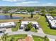 Scenic aerial view of homes, community, lush greenery, and a serene lake at 3252 Scorecard Dr, New Port Richey, FL 34655