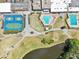 Overhead view of tennis courts, pools, golf course, and landscaping at Seven Springs Golf & Country Club at 3252 Scorecard Dr, New Port Richey, FL 34655