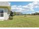View of a well-maintained backyard with a bench and walking trail overlooking a serene pond and lush greenery at 3252 Scorecard Dr, New Port Richey, FL 34655