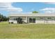 Spacious backyard featuring lush lawn, a patio area, and meticulous landscaping at 3252 Scorecard Dr, New Port Richey, FL 34655