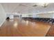 Spacious ballroom with gleaming hardwood floors, ample seating, and chandelier lighting at 3252 Scorecard Dr, New Port Richey, FL 34655